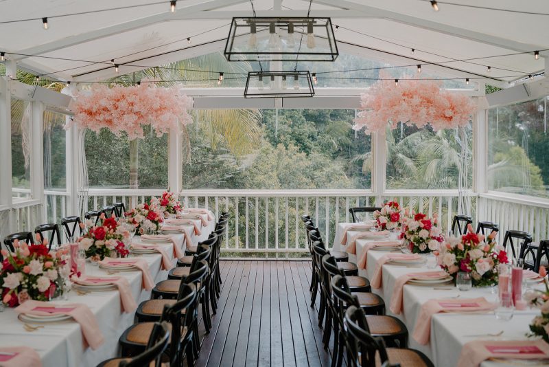 Event styling for a 50th birthday featuring all shades of pink for the table setting and backdrop